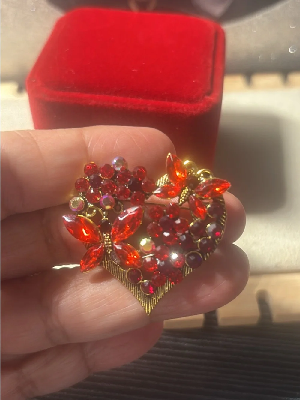 Gold-Tone Red Crystal Heart Brooch with Floral Accents